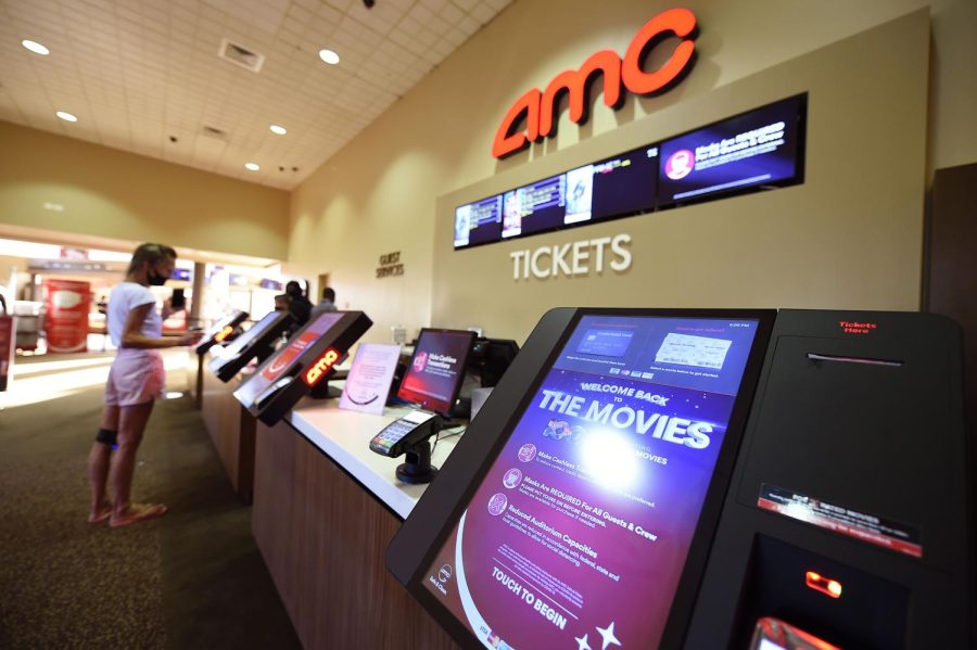Mandatory Credit: Photo by Andrew H Walker/Shutterstock (10766383q) A guest buys ticket at the AMC Wayne 14 movie theater reopening as Covid-19 restrictions continue to ease. AMC Wayne 14 movie theaters. New Jersey, USA - 04 Sep 2020