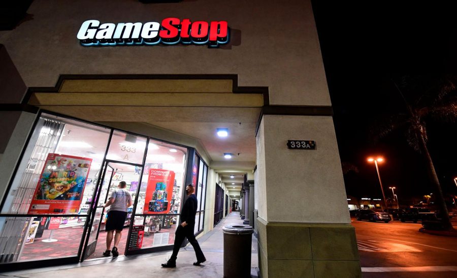 People enter a GameStop store in Alhambra, California on January 27, 2021. An epic battle is unfolding on Wall Street, with a cast of characters clashing over the fate of GameStop, a struggling chain of video game retail stores. Traders have been astounded in recent days by the surge in struggling video game retailer GameStops share price, after a group of amateur investors banded together over the online platform Reddit to fight the Wall Street funds that had pushed its price lower. 