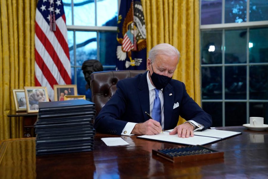 President+Joe+Biden+signs+his+first+executive+order+in+the+Oval+Office+of+the+White+House+on+Wednesday%2C+Jan.+20%2C+2021%2C+in+Washington.%C2%A0