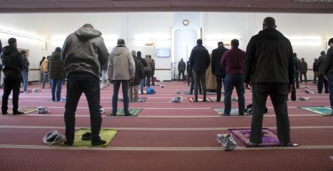 Community members stand for the formal prayer during the Friday service on Feb. 19. There are several poses involved including kneeling with hands cupped in front of the body, as well as standing and leaning forward.