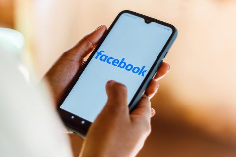 In this photo illustration, a Facebook logo seen displayed on a smartphone.