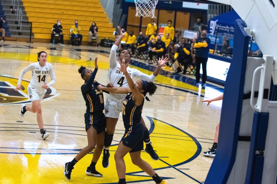 Nila Blackford (4) comes down after shooting over two Toledo defenders. Blackford led Kent State with 13 rebounds and is averaging a double-double this season. Feb. 8, 2020.