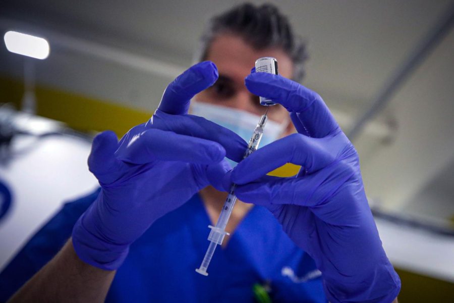 Derenik Gharibian, area pharmacy director Kaiser, prepares Pfizer coronavirus vaccine.