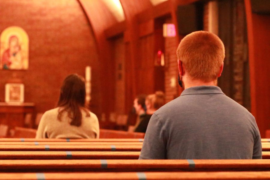 Students sit six feet apart at the Kent State Newman Center during a church service on Tuesday, Feb. 2. 