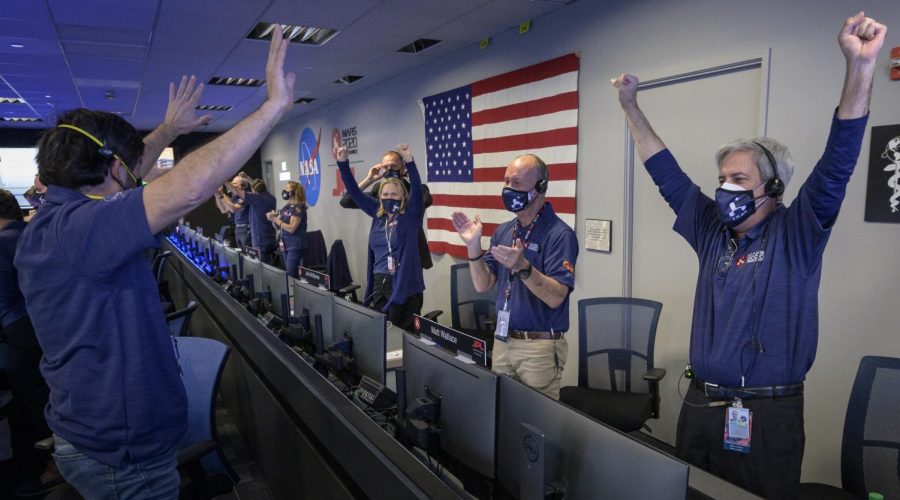 Members of NASA’s Perseverance rover team react in mission control after receiving confirmation the spacecraft successfully touched down on Mars, Thursday, Feb. 18, 2021, at NASAs Jet Propulsion Laboratory in Pasadena, California. A key objective for Perseverance’s mission on Mars is astrobiology, including the search for signs of ancient microbial life. The rover will characterize the planet’s geology and past climate, pave the way for human exploration of the Red Planet, and be the first mission to collect and cache Martian rock and regolith. Photo Credit: (NASA/Bill Ingalls)