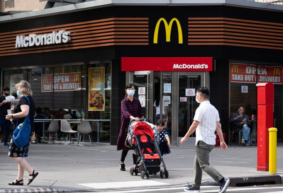 NEW YORK, NEW YORK - SEPTEMBER 27: People walk outside McDonald's on the Upper West Side as the city continues Phase 4 of re-opening following restrictions imposed to slow the spread of coronavirus on September 27, 2020 in New York City. The fourth phase allows outdoor arts and entertainment, sporting events without fans and media production. (Photo by Noam Galai/Getty Images)