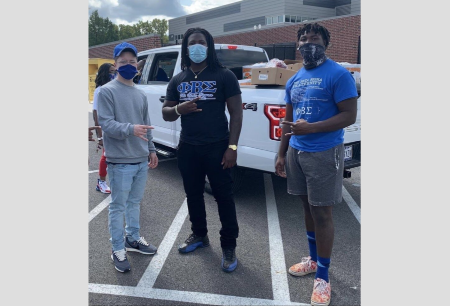 Brothers Quinn McGuire (left), Daymond Williamson (middle) and Calil Cage  (right) of Phi Beta Sigma at a community service event.
