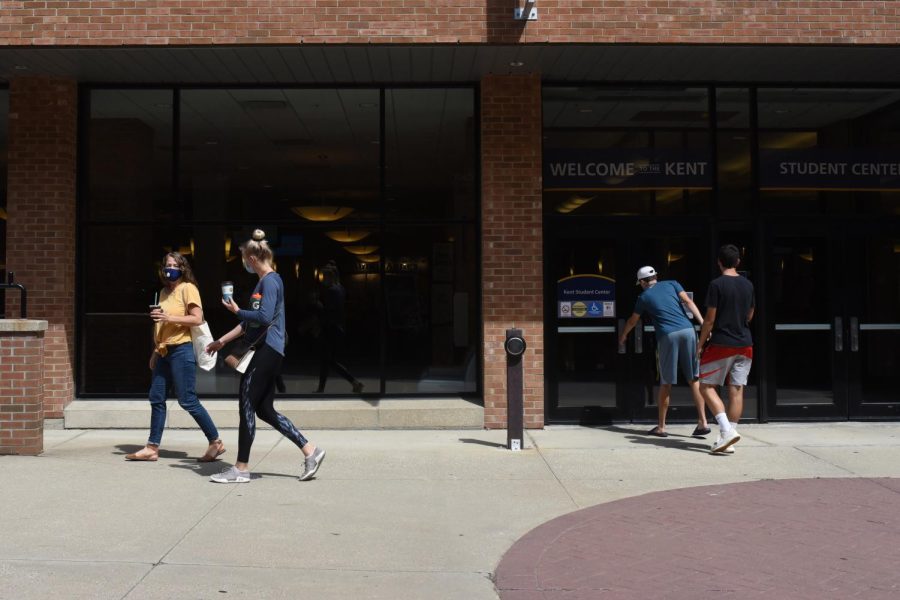 Students walk across the side doors of the Kent Student Center. 