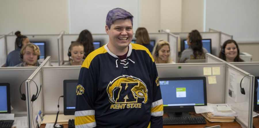 Joshua Fine (center) poses for a picture at the the Kent State PhoneCenter in 2019.