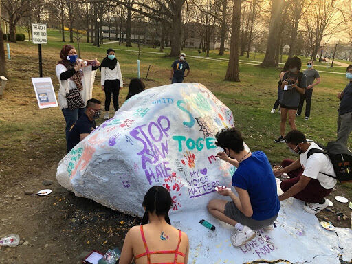 Rally goers painted the campus rock with various messages in support of the Asian community.