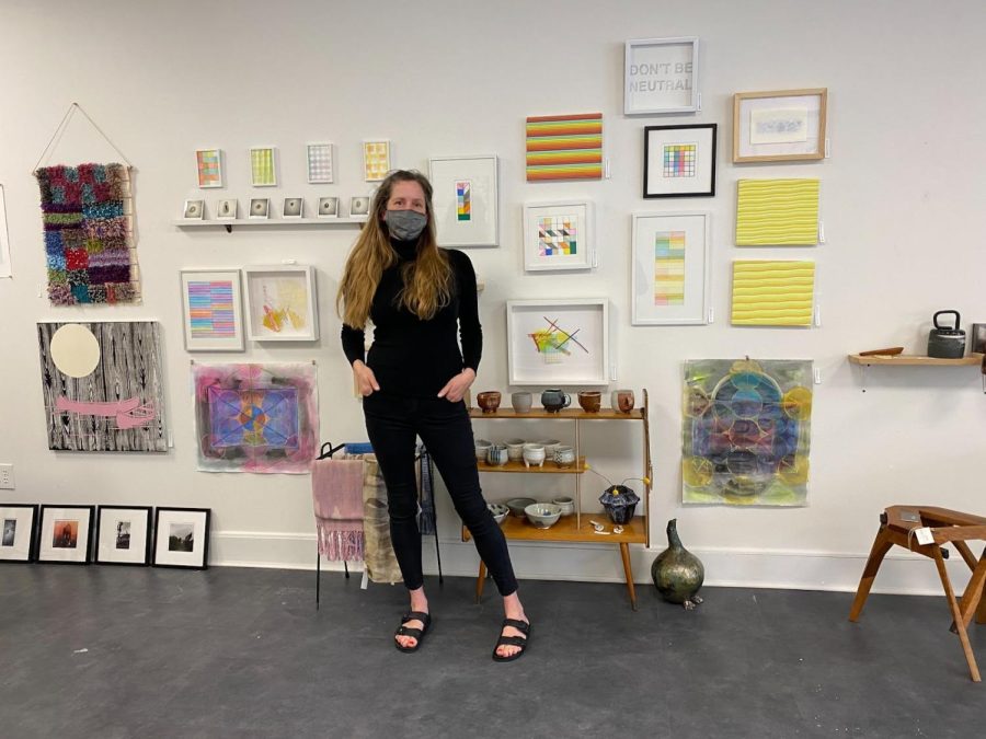 Kelly Dietrick in front of local artists artwork.