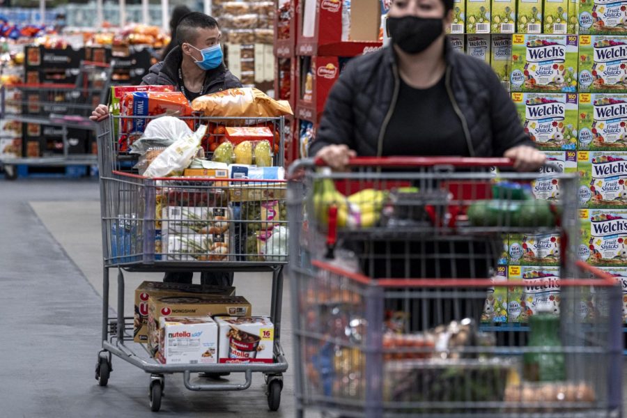 Shoppers wearing protective masks push shopping carts inside a Costco store in San Francisco, California, U.S., on Wednesday, March 3, 2021. Costco Wholesale Corp. is schedule to release earnings figures on March 4. Photographer: David Paul Morris/Bloomberg via Getty Images