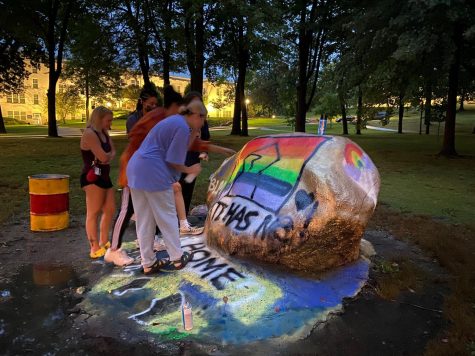 Kent State Students Gracey Jarecke, Savannah Matthews, Ezri Edwards, and Karri Stadulis painted a fist and rainbow flag on The Rock.