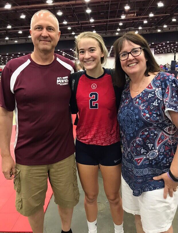 Amelia Perdue with both her parents at a volleyball tournament she participated in when she was in high school.