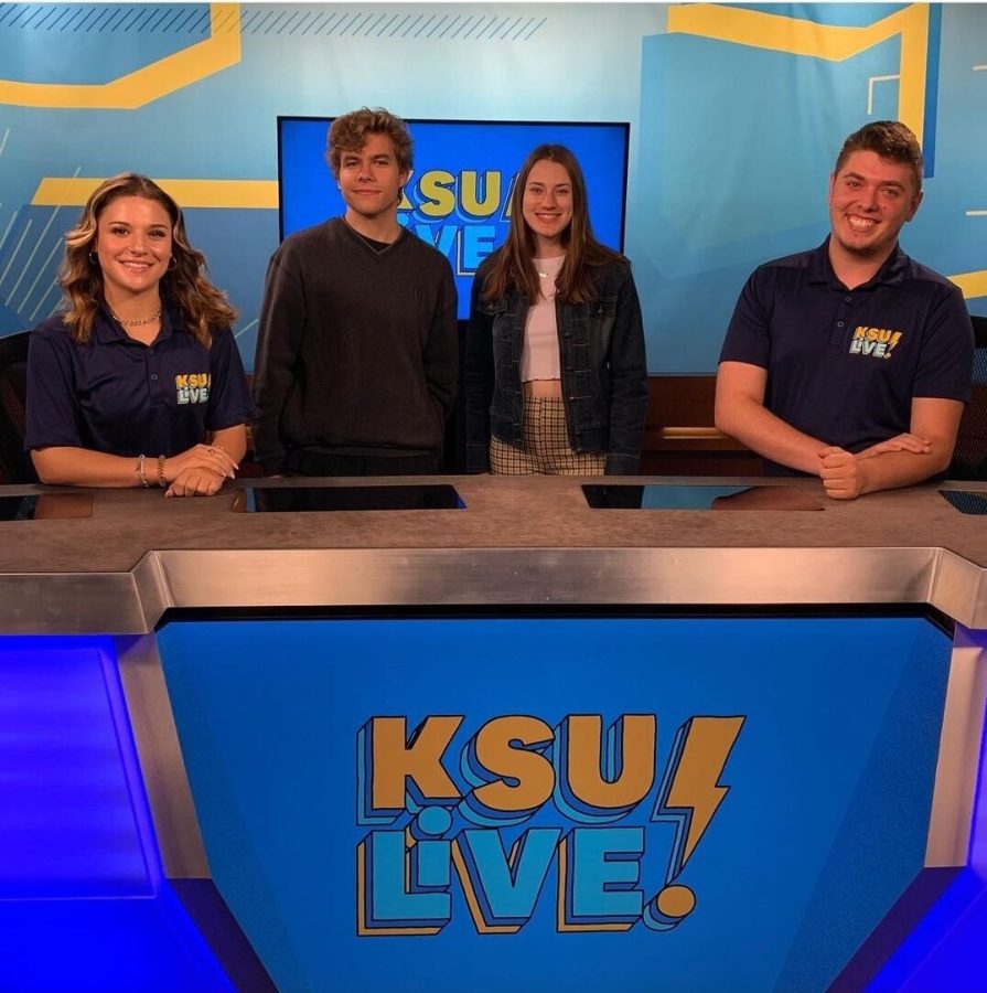 Producers Ben Pagani and Rachel Gross pose with anchors Jenna Gobrecht and Shane Troyano on the set of KSU Live! in the Franklin Hall studio.