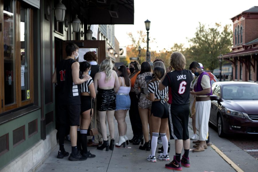 A large group of students wait outside of Ray’s Place on Oct. 31, 2020. Ray’s Place was busy as they try to help guests but also stay safe amid the pandemic. 