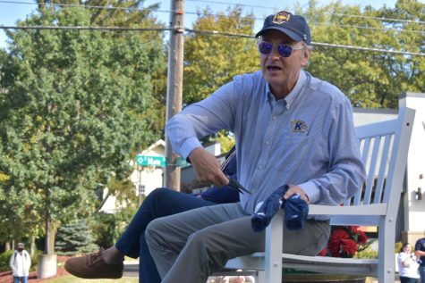 Kent States President, Todd Diacon, hands out masks and t-shirts from his float in the Homecoming Parade on Sat. Oct. 2, 2021.