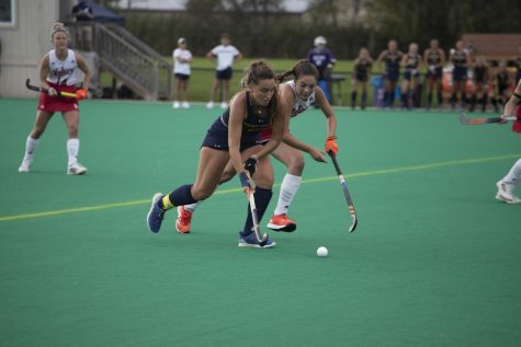 Senior midfielder Helena Cambra Soler (22) dribbles the ball down the field during the field hockey game on Oct. 10, 2021. Kent State won 2-1 in overtime against Indiana University.