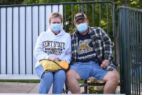 Kent State Alumni, Cindy Watkins 84 (left) and Don Michalak 72 (right) wait to watch the Homecoming Parade on Sat. Oct. 2, 2021