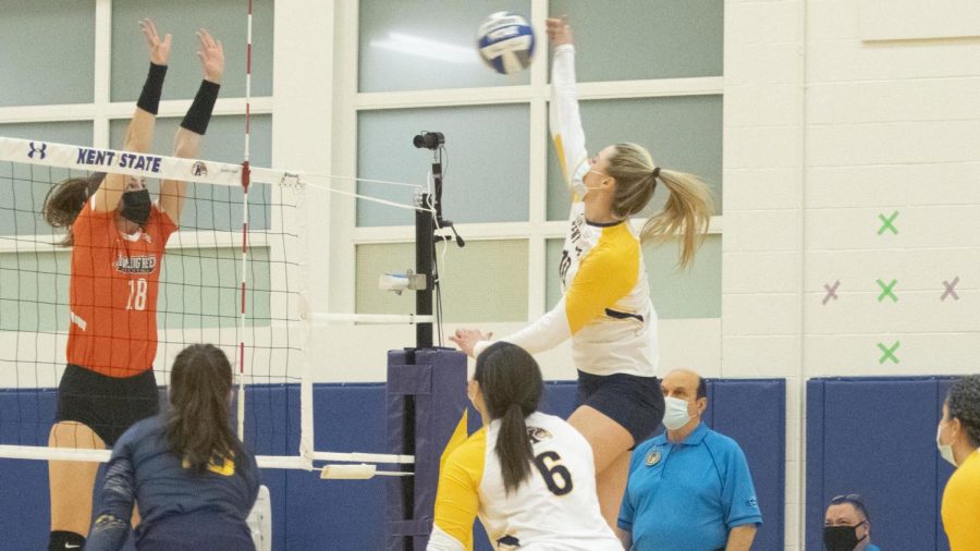 Junior opposite hitter Morgan Copley hits the ball over the net during a Kent State volleyball game. 