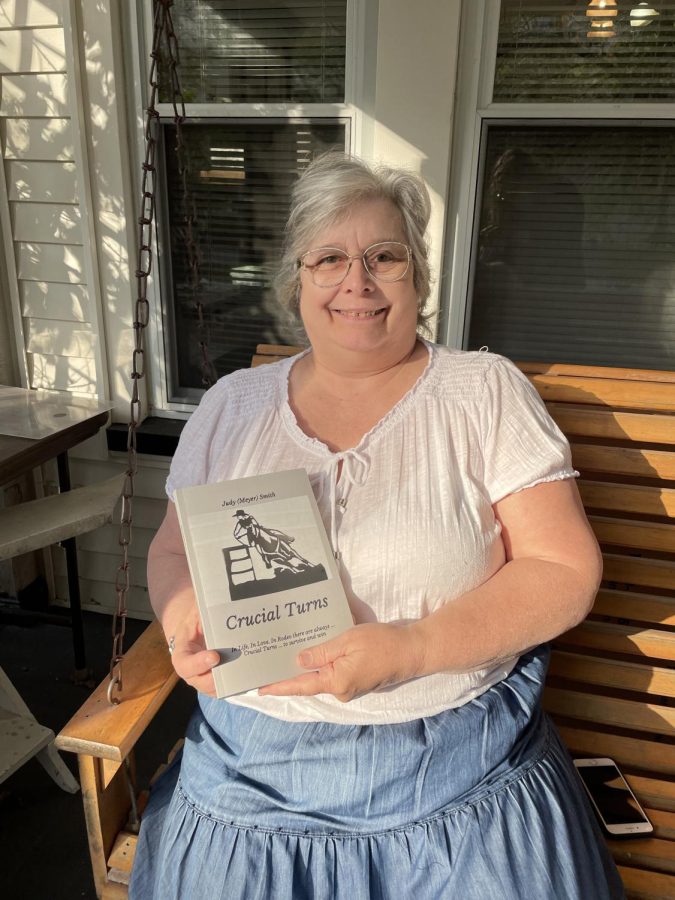 Judy Smith, owner of the houses located at 226 and 230 South Lincoln Street, holds the book Crucial Turns that references the street corner where shes spent most of her life.