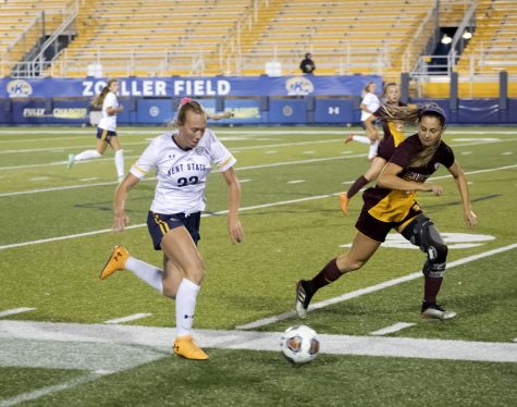 Redshirt senior Karly Hellstrom (23) dribbles the ball toward the goal during the soccer game against Central Michigan University on Oct. 21, 2021. Kent State and Central Michigan tied 1-1 during double overtime.