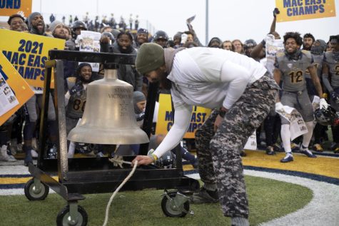 Head coach Sean Lewis rings the Starner Victory Bell to celebrate the Kent State Football team beating Miami University and advancing to the MAC championship.