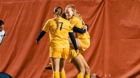 Members of the Kent State soccer team celebrate their semifinal playoff win over Ohio University in Bowling Green, Ohio on Friday, Nov. 4. 