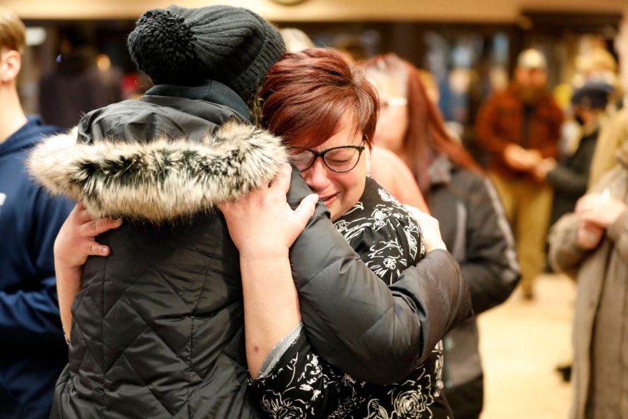 People hug during a vigil after a shooting at Oxford High School at Lake Pointe Community Church in Lake Orion, Michigan on November 30, 2021. - A 15-year-old student opened fire at his Michigan high school on November 30, killing three teenagers and wounding eight other people before surrendering to police, authorities said, in what was the deadliest US school shooting so far this year. (Photo by JEFF KOWALSKY / AFP) (Photo by JEFF KOWALSKY/AFP via Getty Images)