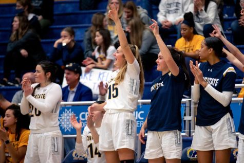 Members of the Kent State womens basketball team cheer for sophomore guard Casey Santoro during her triple-double against Clarion University on Saturday, Dec. 11 in Kent, Ohio. 