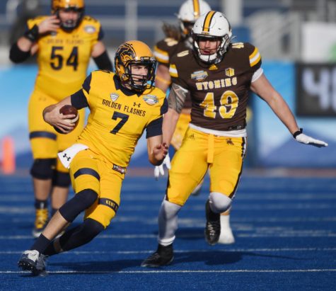 Kent State quarterback Dustin Crum runs past Wyoming defenders for a gain in the first half of the Famous Idaho Potato Bowl game in Boise, Idaho on Dec. 21, 2021. Kent State lost to the Cowboys 52-38. Photo by Bob Christy/ Courtesy of Kent State University