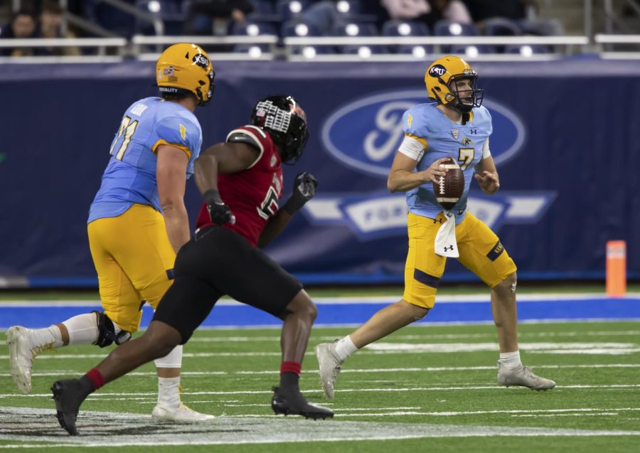 Graduate student quarterback Dustin Crum (7) looks for a pass during the MAC Championship against Northern Illinois University in Detroit, Michigan on Dec. 04, 2021. Kent State lost to NIU 41-23.
