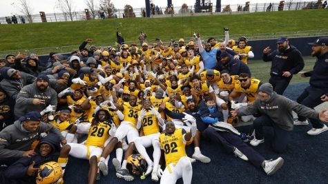 Members of the Kent State football team celebrate its win against Akron on Saturday, Nov. 20 in Akron, Ohio.