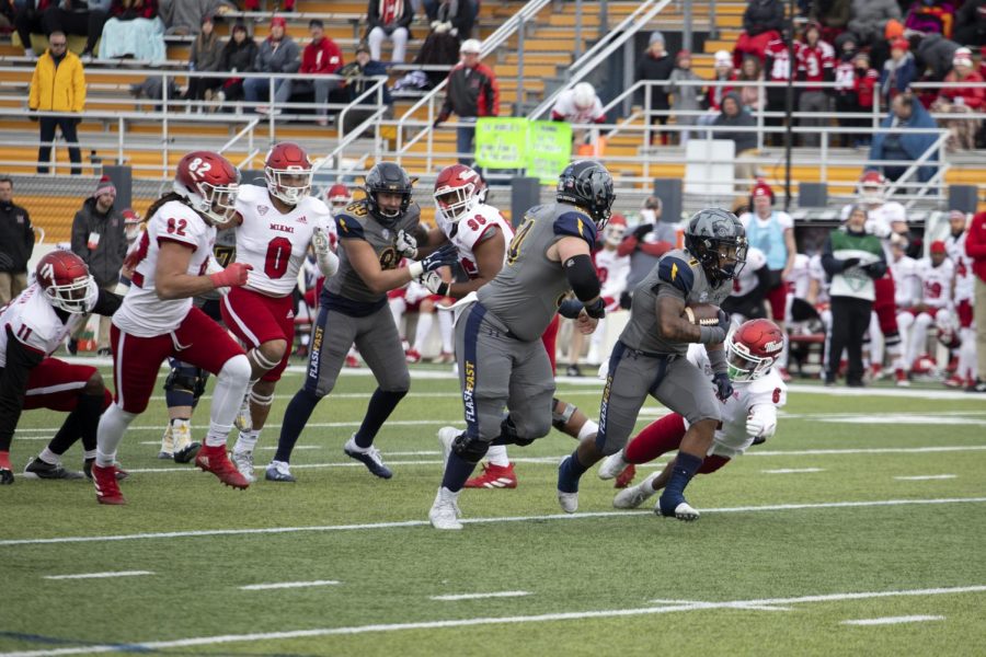 Sophomore running back Marquez Cooper (1) runs the ball during the football game against Miami University on Nov. 27, 2021. Kent State beat Miami 48-47 in overtime.