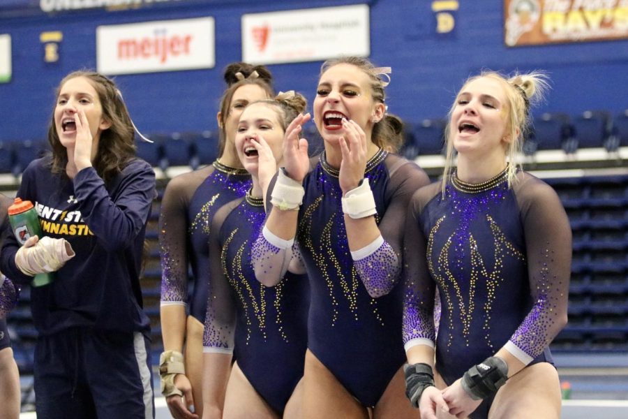 Members of the Kent State gymnastics team cheer during the Blue and Gold exhibition meet in Kent, Ohio on Sunday, Dec. 12. 