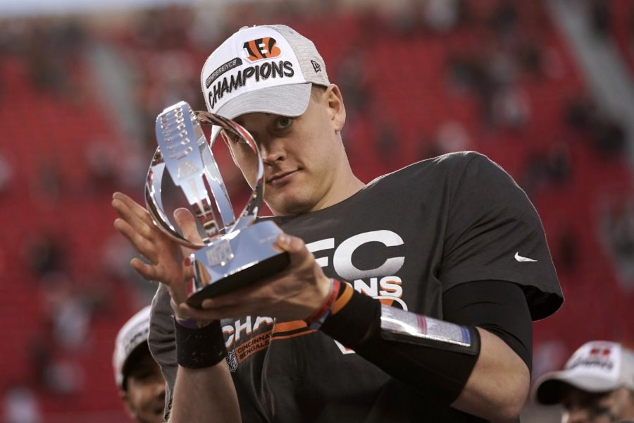 Cincinnati Bengals quarterback Joe Burrow (9) holds the Lamar Hunt trophy after an AFC championship NFL football game against the Kansas City Chiefs, Sunday, Jan. 30, 2022, in Kansas City, Mo. The Bengals won 27-24 in overtime. (AP Photo/Charlie Riedel)