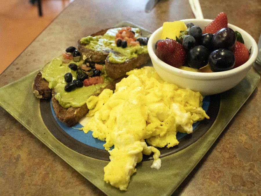 Avocado toast, served with scrambled eggs and fruit, at Over Easy. Over Easy is located at 152 Franklin Ave.