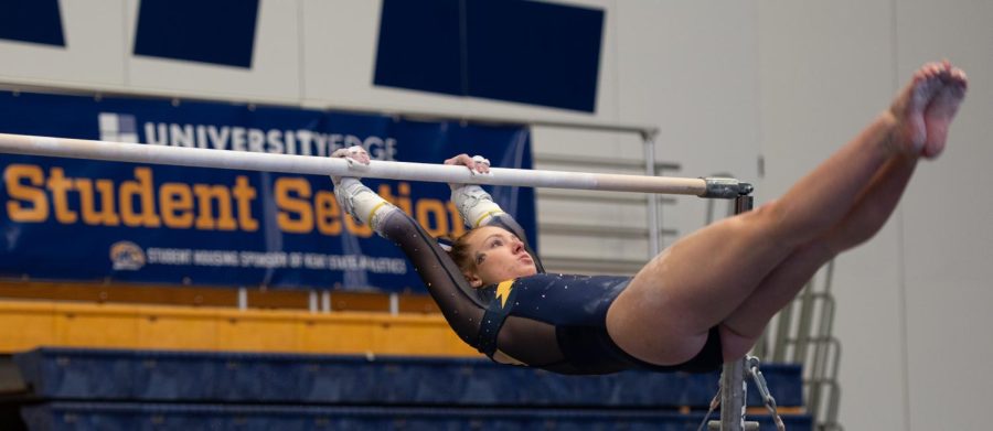 Rachel DeCavitch swoops through the air on the uneven bars during the gymnastics meet on Jan. 28, 2022.