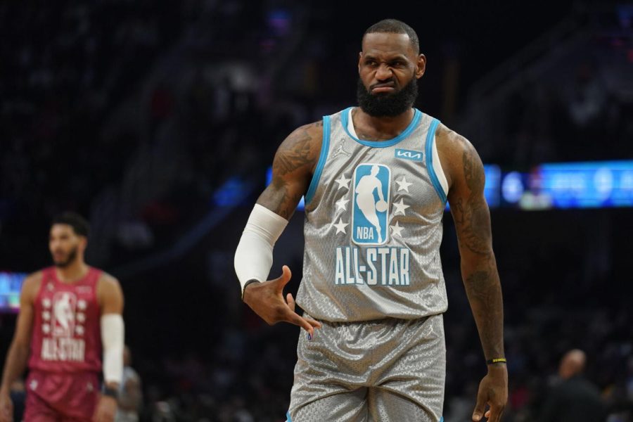 Los Angeles Lakers LeBron James reacts to celebrities in the front row as he plays in the first half of the NBA All-Star basketball game, Sunday, Feb. 20, 2022, in Cleveland. (AP Photo/Charles Krupa)