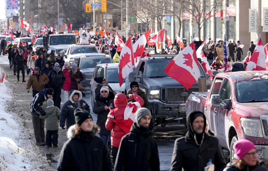 Trucks+and+supporters+travel+down+Bloor+Street+during+a+demonstration+in+support+of+a+trucker+convoy+in+Ottawa+protesting+COVID-19+restrictions%2C+in+Toronto%2C+Saturday%2C+Feb.+5%2C+2022.+%28Nathan+Denette%2FThe+Canadian+Press+via+AP%29