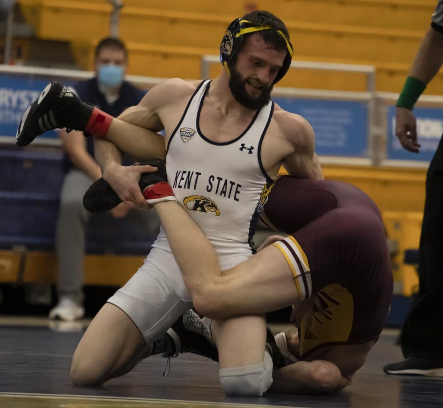 Senior Kody Komara attempts to pin a Central Michigan University wrestler during the match on Feb. 6, 2022. Kent State lost 32-9.