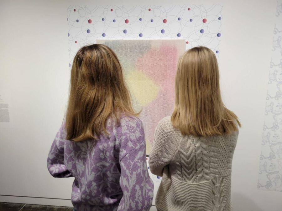 Kent State Students Romy Anderson (left) and Molly Hudson (right) admire a piece of art in the Line by Line Gallery.