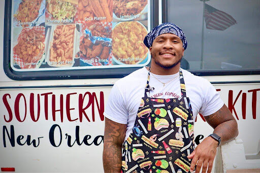 Will Matthews stands outside of the Southern Comfort Food Truck. The 2019 Kent graduate wanted to bring food to Kents campus that reflected the food he ate back home. 