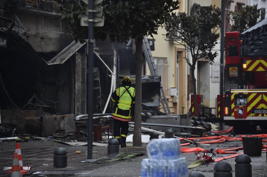A+firefighter+stands+near+to+debris+and+burned+houses+after+an+explosion+in+Saint-Laurent-de-la-Salanque%2C+on+February+14%2C+2022.+-+Five+people+died+on+the+night+of+February+13%2C+2022%2C+during+a+fire+triggered+by+an+explosion+in+a+village+in+the+Pyrenees-Orientales.+%28Photo+by+RAYMOND+ROIG+%2F+AFP%29+%28Photo+by+RAYMOND+ROIG%2FAFP+via+Getty+Images%29