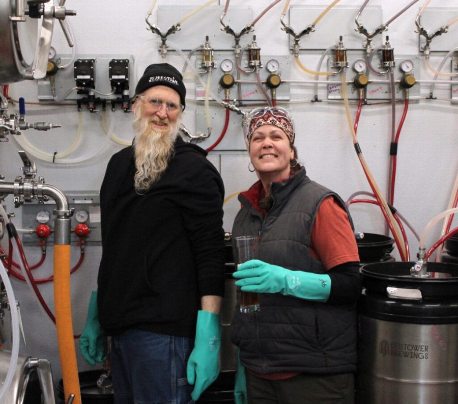 Karl Walter, assistant brewer at the Bell Tower Brewing Company, and Jennifer Hermann in the cooler at the Bell Tower Brewing Company.