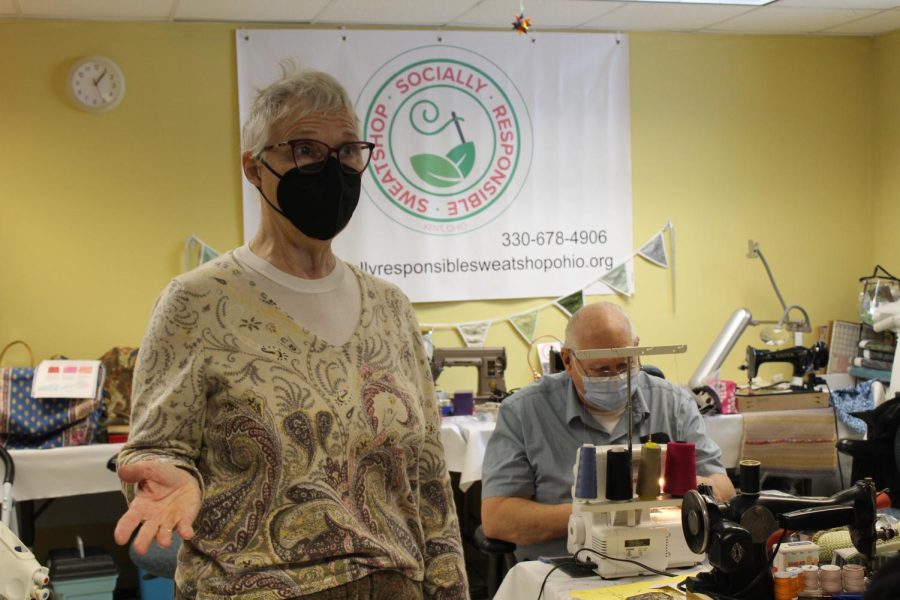 Mary Ann Kasper (left) discussing recycled fabrics and Frank Kohout (right) working on a project.
