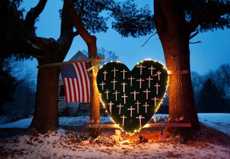 FILE - In this Dec. 14, 2013, file photo, a makeshift memorial with crosses for the victims of the Sandy Hook Elementary School shooting massacre stands outside a home on the first anniversary of the tragedy in Newtown, Conn. (AP Photo/Robert F. Bukaty, File)
