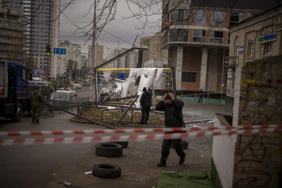 Police officers inspect area after an apparent Russian strike in Kyiv Ukraine, Thursday, Feb. 24, 2022. Russian President Vladimir Putin on Thursday announced a military operation in Ukraine and warned other countries that any attempt to interfere with the Russian action would lead to consequences you have never seen. (AP Photo/Emilio Morenatti)