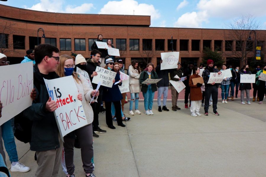Kent State students stand and chant on the K in protest of house bill 327 while holding the signs of names that would not be able to be taught under the bill on Wednesday, March 9.