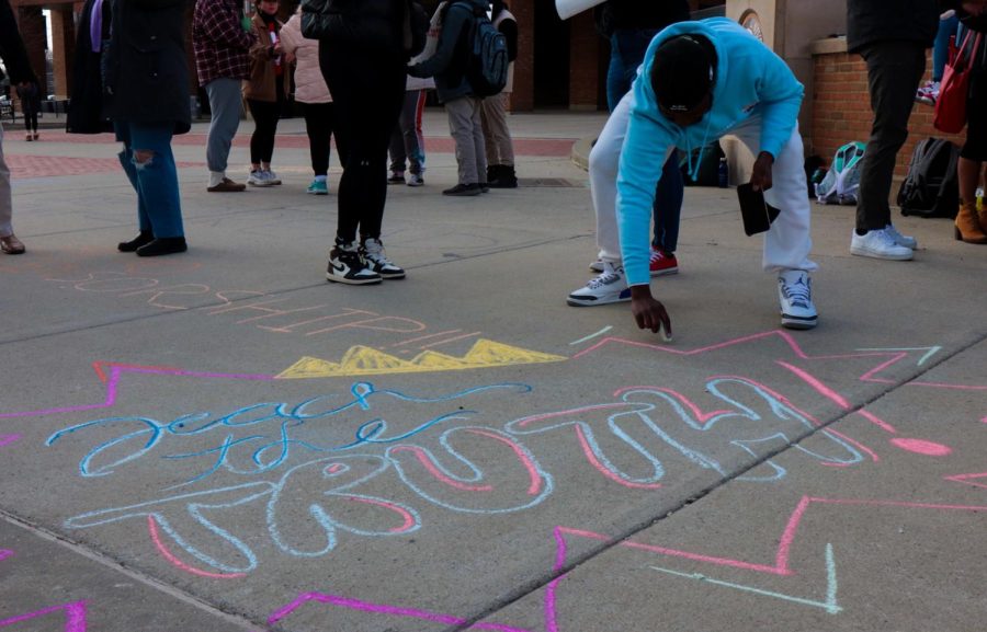 The students at the protest against house bill 327 drew messages to the other students with chalk on the K after the protest today on Wednesday, March 9. This student, AJ, wrote teach the truth in bright colors.